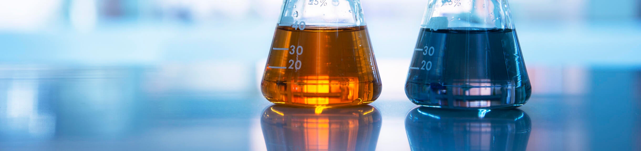 beakers of liquid chemicals on laboratory countertop