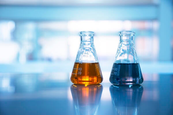 beakers of liquid chemicals on laboratory countertop