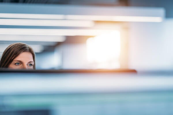 person looking out of cubicle